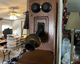 An antique telephone mounted on the wall.