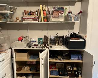 Another view of the fully stocked craft room. Includes some technology, office supplies, and more books.