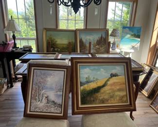 A room full of original paintings. Each of them is by a different artist.