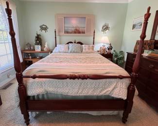 Full size four poster bed and linens, dresser with mirror and side tables. Coastal wall art and decor