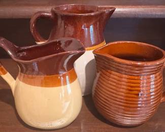 Roseville pitcher and other stoneware pitchers