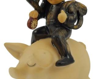 564 - Hummel Chimney Sweep on Pig Figure 4.5" (Description): Hummel figurine depicting a chimney sweep boy riding on a pig. The figure shows a young boy dressed in traditional black chimney sweep attire with cap, carrying his tools and equipment over his shoulder. He sits astride a cream-colored pig with a contented expression. Measures 4.5 inches tall.