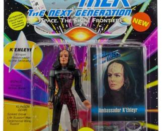 545 - Playmates Star Trek TNG K'Ehleyr Figure (Description): Unopened Playmates Star Trek The Next Generation action figure in original packaging. This figure features K'Ehleyr, the Klingon Ambassador to the Federation. The package includes bonus Klingon action base and Klingon gear accessories including spike