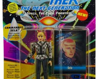 539 - Playmates Star Trek TNG Commander Sela (Description): Unopened Playmates Star Trek The Next Generation action figure in original box featuring Commander Sela. The figure remains sealed in its original packaging.
