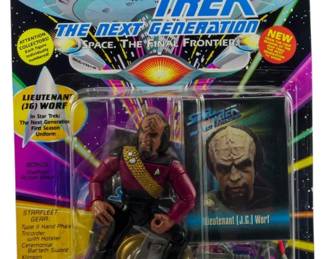 524 - Unopened Star Trek Next Generation Figure (Description): Unopened Star Trek The Next Generation figure in original box. This collectible action figure remains factory sealed in its original packaging.