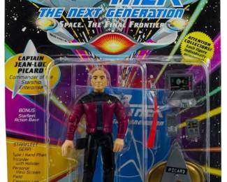 532 - Playmates Star Trek TNG Picard Figure (Description): Unopened Playmates Star Trek The Next Generation action figure in original packaging featuring Captain Jean-Luc Picard. The figure remains sealed in its original box, never opened.