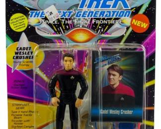 525 - Star Trek TNG Cadet Wesley Crusher Figure (Description): Unopened Star Trek The Next Generation action figure in original box featuring Cadet Wesley Crusher. The figure remains sealed in its original packaging.