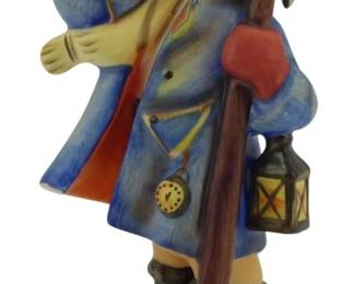 559 - Hear Ye, Hear Ye Hummel Figurine 5.5" (Description): Hear Ye, Hear Ye Hummel figurine depicting a young town crier in a blue coat with red accents, holding a bell aloft while carrying a walking staff and lantern. The charming figure wears traditional attire including a brown cap, boots, and carries a pocket watch. Measures 5.5 inches tall.