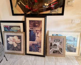 Assorted framed art prints.