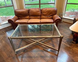 Glass top coffee table. Brass