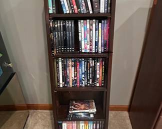 Assorted DVD Collection on Dark Wood MultiTiered Shelf