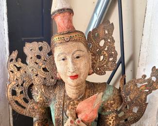 Thai wood-carved kneeling deity statue