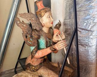 Thai wood-carved kneeling deity statue