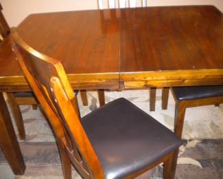 Ashley furniture table with hidden center leaf and 4 chairs LIKE NEW