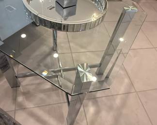 Modern Mirrored Glass Coffee Table with Chrome Accents and Starburst Detail
