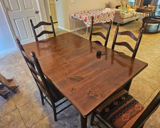 The solid wood Amish looking dining room set dark wood, comes with two leaves which we have set aside so you can see them six chairs and a beautiful matching hutch, almost looks like it belongs in a castle