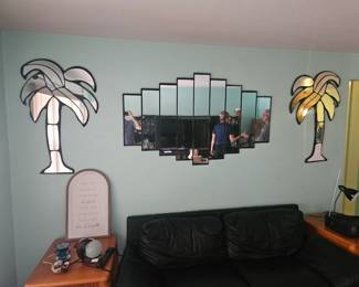 Again another photo that is not located here. This is at next week's estate sale in indialantic beautiful home You're stepping into a set of Miami vice TV show. We have two palm tree mirrors or $75 each and the middle mirror is also $75