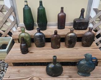 An assortment of old glass hand blown and stamped bottles