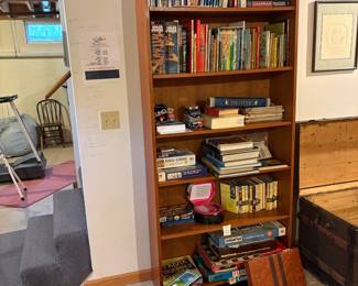 Wooden Bookshelf with Assorted Books and Board Games