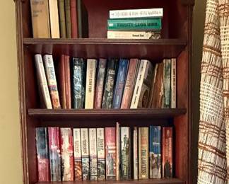 Asian inspired tall, narrow bookcase.