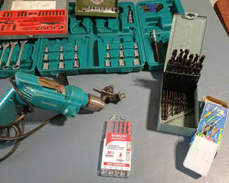 Lot 65: Makita Corded drill with drill bits, wrenches, and socket sets
