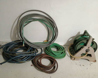 Lot 69: Assorted garden hoses and hose reel