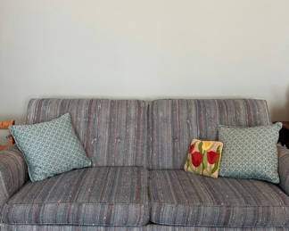 Lot 18: Blue striped sleep sofa with decorative throw pillows