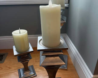 Lot 14: Set of three metal pillar candle holders with candles