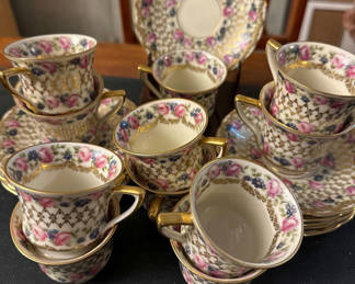 Lot 74: Bohemian porcelain teacups, saucers, and plate with floral and gold trim