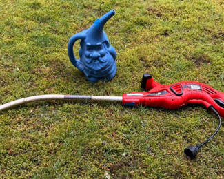 Lot 84: Red electric string trimmer and blue garden gnome statue
