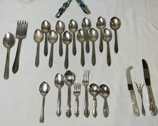 Lot 15: Assorted silverware set with spoons, forks, and knives