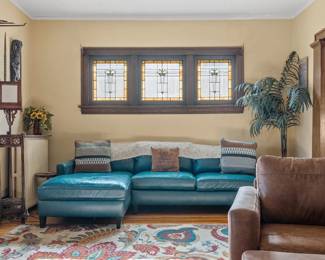 Leather sectional, leather arm chair, faux plant, throw pillows, lamps