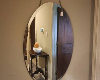 Oval mirror hanging by chain