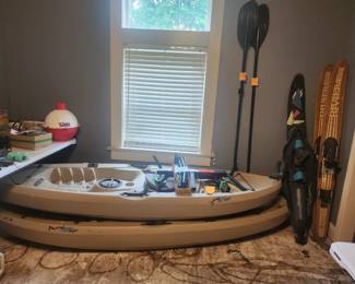 Pair of fishing kayaks, oars, and skis
