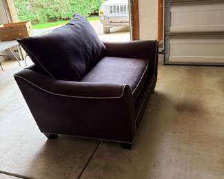Dark leather accent chair with wide modern arms