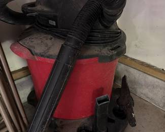 Red shop vacuum with hose