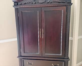 Dark wood armoire storage cabinet