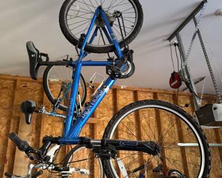 Blue road bike hanging in garage