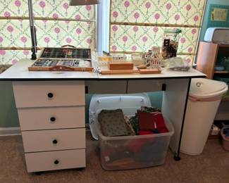 Desk, sewing accessories, and fabrics