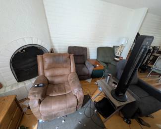 Four recliners in living room, 1 more in office with red armchair, multiple end tables, accent table with storage