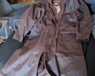Stockman Duster Coat from the Outback Trading Company. Model number ST. 2059 rugged, extra-long waterproof oilskin coat designed for harsh weather and outdoor work.