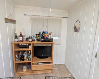 Wooden storage with shelves, entertainment center, TV, DVD player, decorative Mexican vases