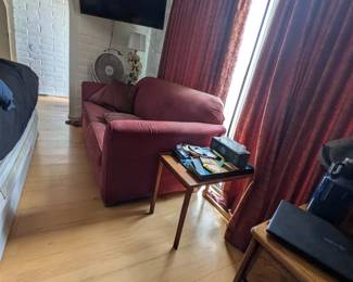 Red couch, end tables, tv