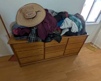 Lower dresser with 9 drawers, shirts, cowboy hat, chair