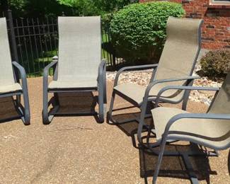 Four Tan and Black Sling Patio Chairs