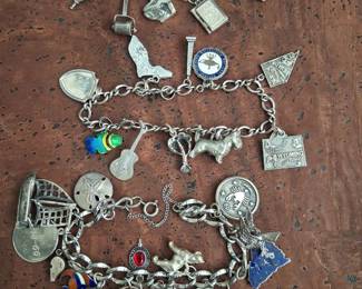 Vintage sterling silver charm bracelets with lots of charms.