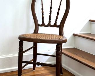 One of two matching antique balloon back sidechairs