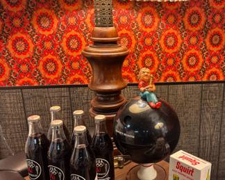 1984 Los Angeles Olympics Commemorative Coca-Cola Bottles, Mid Century Carved Wood Table Lamp with Pleated Shade, 1971 Bowling Ball Decanter, 1970s Squirt Salt & Pepper Shakers
