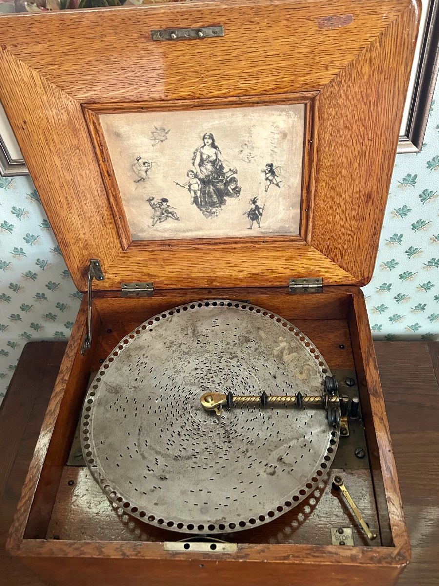 Regina Disc Music Box:  A remarkable Regina disc music box and one of the signature collectibles in this estate. Beautiful craftsmanship, rich wood tones, and timeless appeal for collectors, antique décor enthusiasts, and lovers of mechanical history.