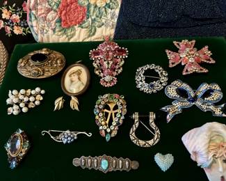 Vintage Jewelry Collection  An extensive collection of vintage jewelry including rhinestone brooches, floral pins, costume jewelry, statement pieces, and collectible accessories spanning multiple eras.
